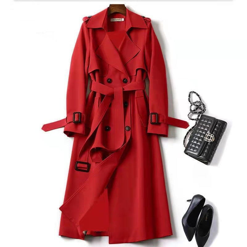 Red trench coat with black handbag and shoes on a white background