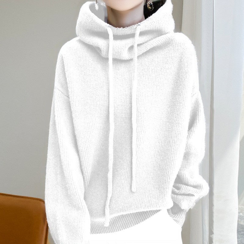 White hoodie worn by a person against a neutral background