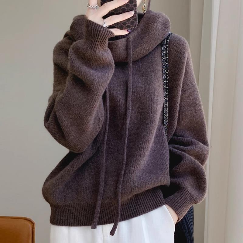 Brown oversized hoodie worn by a person against a neutral background