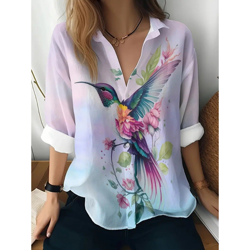 Woman wearing a blouse with a colorful hummingbird design on a white background