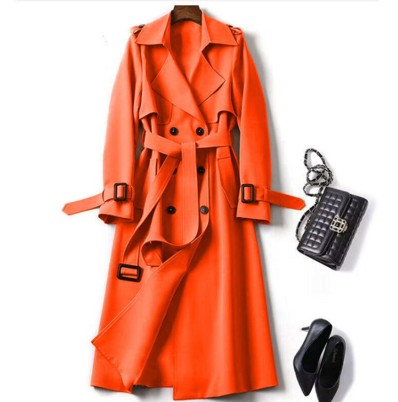 Orange trench coat with black accessories on a white background