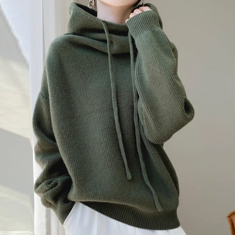 Green sweater worn by a person with a neutral background