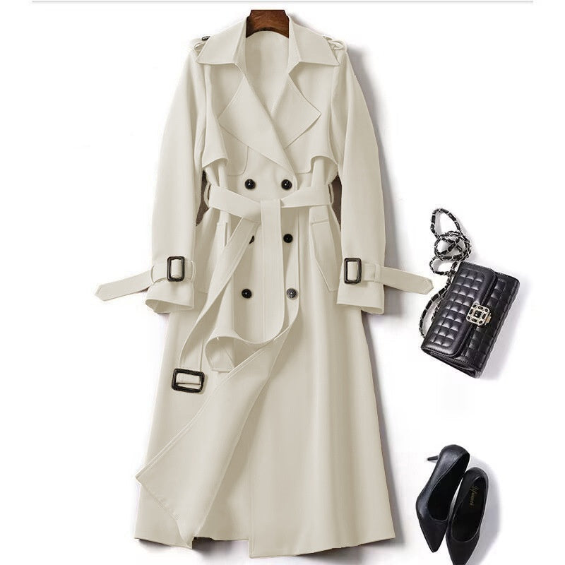 Beige trench coat with black accessories on a white background