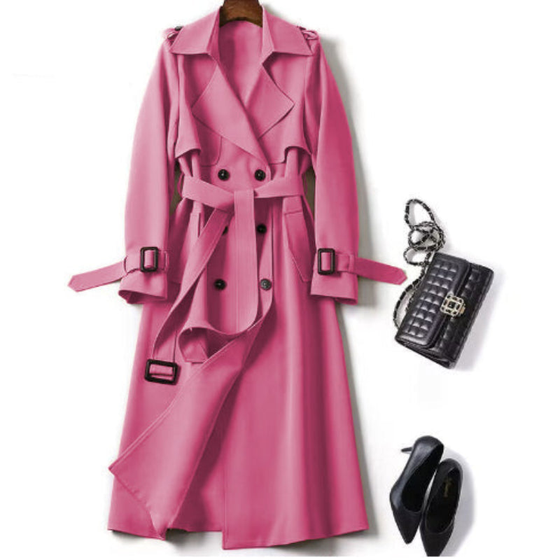 Pink trench coat with black accessories on a white background